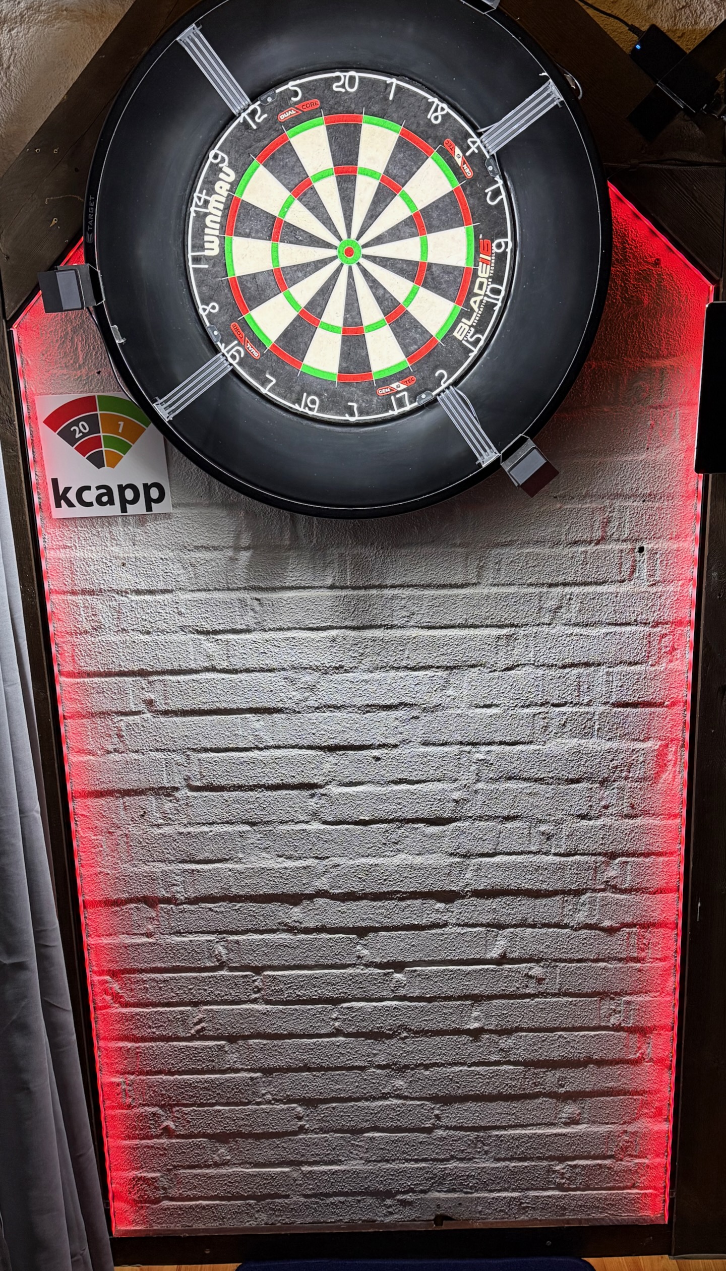 final setup showing the LED strips mounted on the wall with dartboard